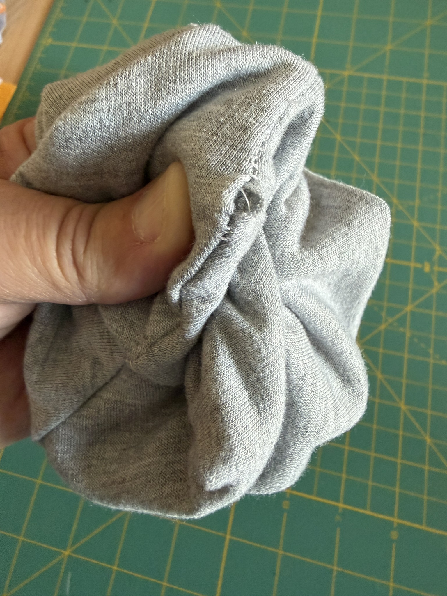 Close up of sewing mistake where knit edge wasn't caught in the seam.