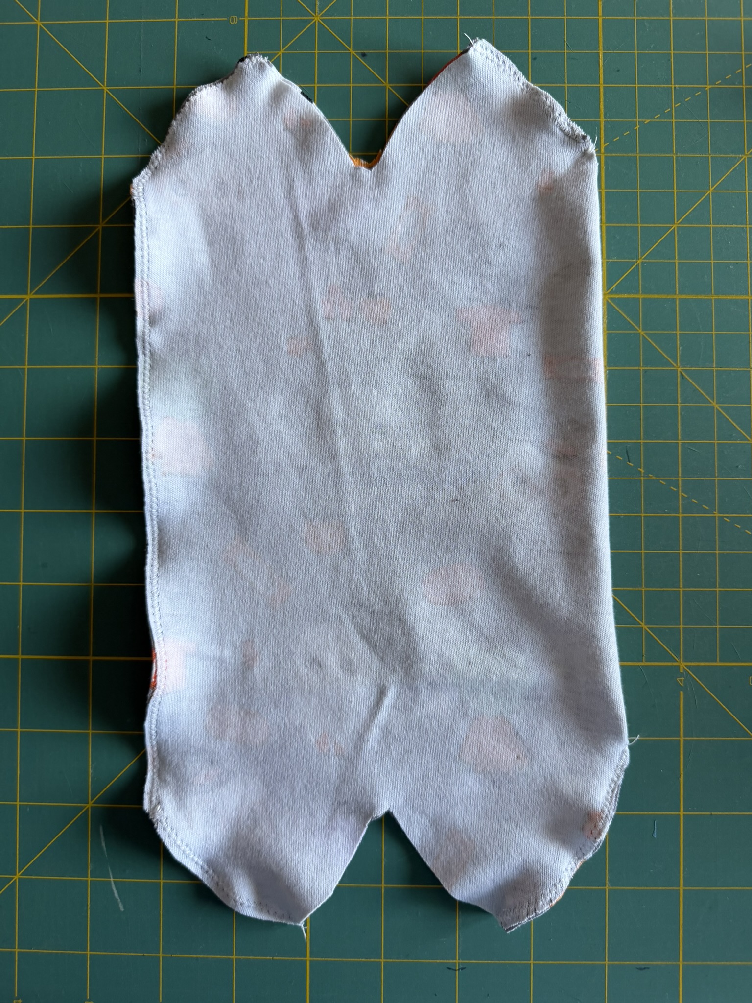 Knit fabric edges sewn together using zigzag stitch.