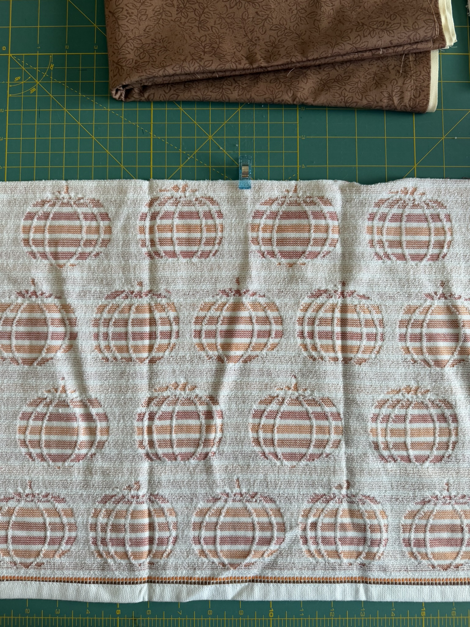 Center of the pumpkin towel marked with a sewing clips.