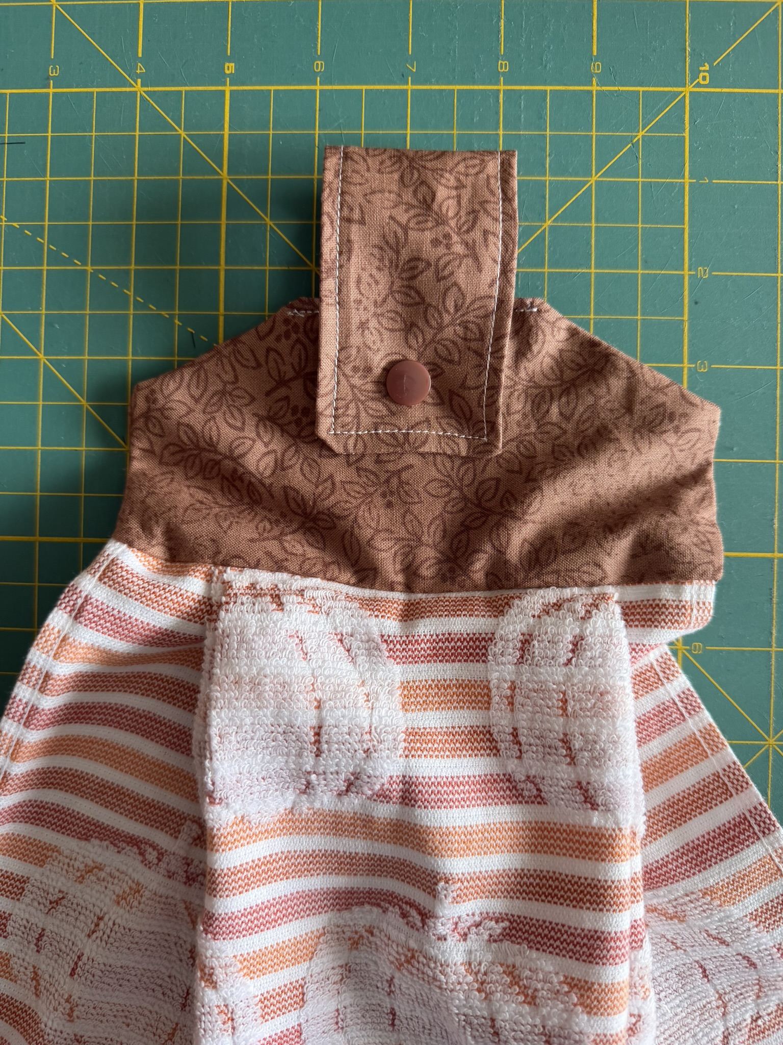 Pumpkin towel with a hanging tab to use it in the kitchen without it falling off of the dishwasher.