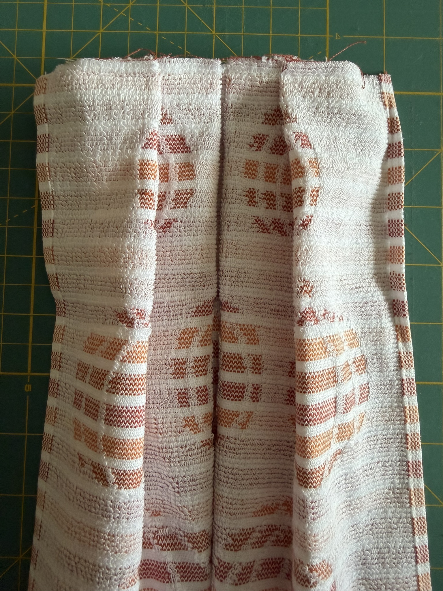 Pumpkin towel with the top folds sewn together.